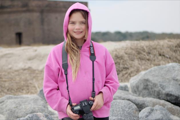   Francine (Frankie) Gross holds her Cannon camera during the Wild Amelia kids' photography session at Fort Clinch on Saturday.  By Marisa DeMar/News-Leader