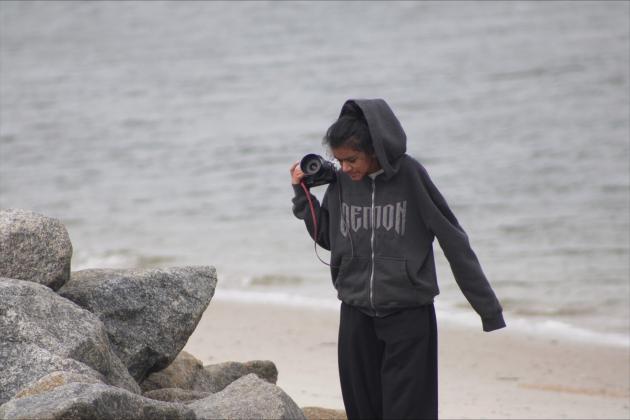 Adhya Murthy walks the Fort Clinch shoreline in search of photography subjects.  By Marisa DeMar/News-Leader