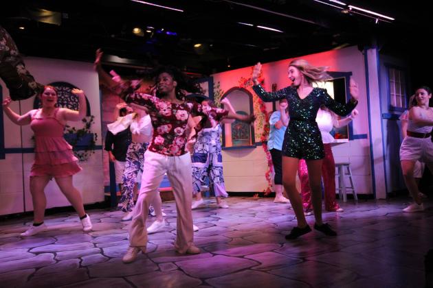 The ensemble and lead actor Samantha Anderson as Sophie on the right, performs a dance number in Amelia Musical Playhouse's rendition of Mamma Mia.  By Marisa DeMar 