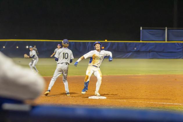 Dalton Janey celebrates as he reaches third base on a triple in a game against Sandalwood on Feb. 17. Photo by Ashley Chandler/News-Leader