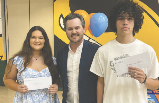 Hannah Clark and Slade Hernandez-Peterson, 2025 scholarship winners from Yulee High, stand with Institute for Enterprise Board President Bryan Poynter. Submitted photo