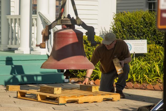 Workers from White’s Clock &amp; Carillon removed the bell from the belfry at First Presbyterian Church on 6th Street in downtown Fernandian Beach. The bell was first hung in 1859. Photo by Ashley Chandler/News-Leader