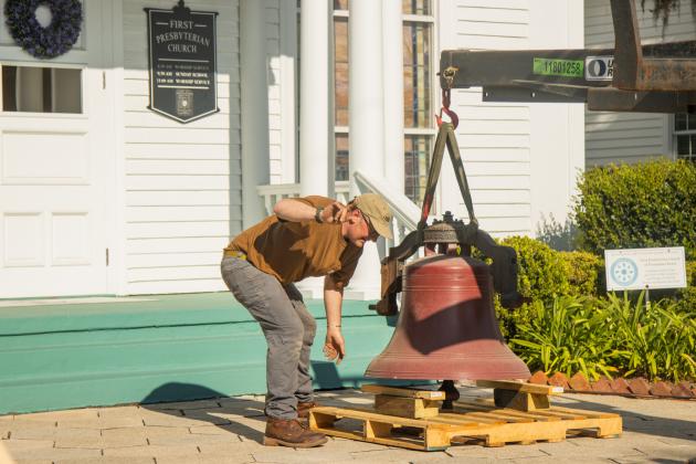 Workers from White’s Clock &amp; Carillon removed the bell from the belfry at First Presbyterian Church on 6th Street in downtown Fernandian Beach. The bell was first hung in 1859. Photo by Ashley Chandler/News-Leader
