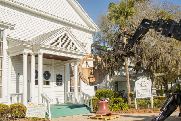 Workers from White’s Clock &amp; Carillon removed the bell from the belfry at First Presbyterian Church on 6th Street in downtown Fernandian Beach. The bell was first hung in 1859. Photo by Ashley Chandler/News-Leader