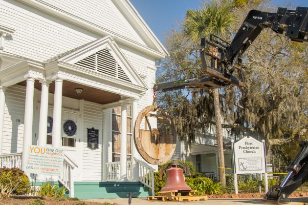 Workers from White’s Clock &amp; Carillon removed the bell from the belfry at First Presbyterian Church on 6th Street in downtown Fernandian Beach. The bell was first hung in 1859. Photo by Ashley Chandler/News-Leader