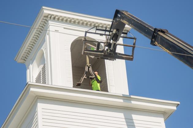 Workers from White’s Clock &amp; Carillon removed the bell from the belfry at First Presbyterian Church on 6th Street in downtown Fernandian Beach. The bell was first hung in 1859. Photo by Ashley Chandler/News-Leader