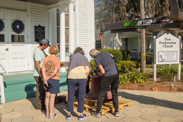 Workers from White’s Clock &amp; Carillon removed the bell from the belfry at First Presbyterian Church on 6th Street in downtown Fernandian Beach. The bell was first hung in 1859. Photo by Ashley Chandler/News-Leader