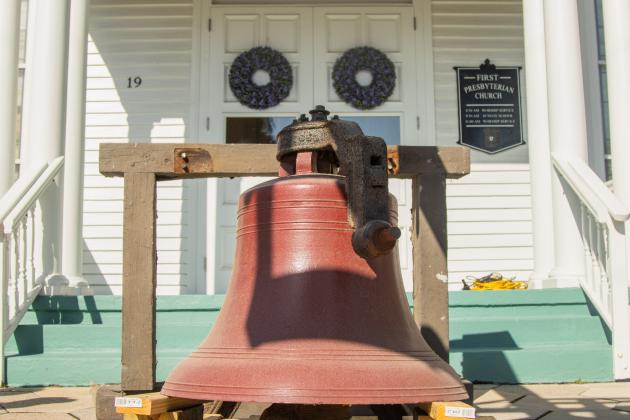 Workers from White’s Clock & Carillon removed the bell from the belfry at First Presbyterian Church on 6th Street in downtown Fernandian Beach. The bell was first hung in 1859. Photo by Ashley Chandler/News-Leader