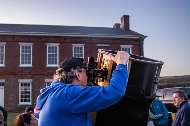Mike Napper of the Northeast Florida Astronomical Society adjusts his telescope Friday during the Astronomy Night at Fort Clinch State Park. Photo by Ashley Chandler/News-Leader