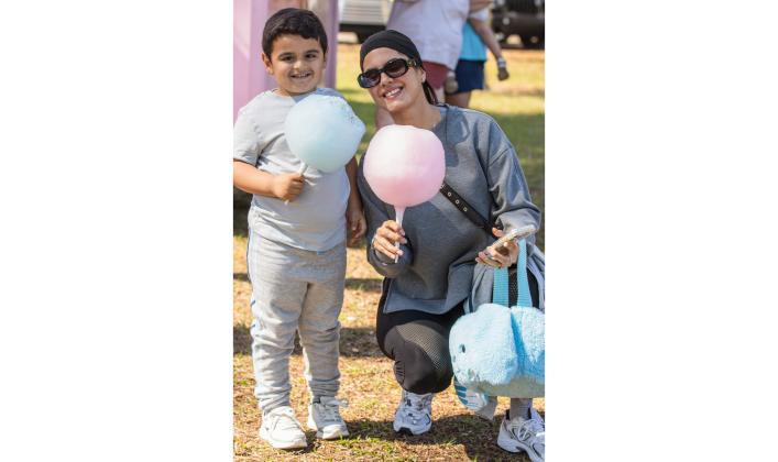 Jessican Cambar and Liam Maldonado stop by the Cloud Crunch food truck for cotton candy after the annual Fernandina Beach Easter Egg Hunt. 