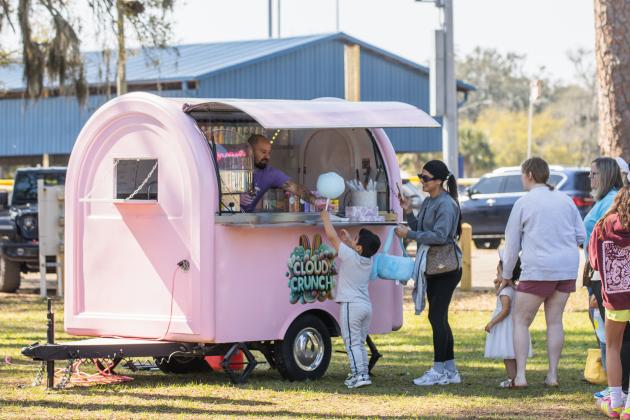 Jessican Cambar and Liam Maldonado stop by the Cloud Crunch food truck for cotton candy after the annual Fernandina Beach Easter Egg Hunt. Photo by Ashley Chandler/News-Leader