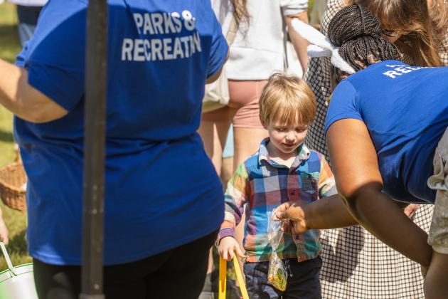 Rosanda Thomas, right, of Fernandina Beach Parks and Recreation, hands out goodie bags at Fernandina Beach’s second annual Easter Egg Hunt. Photo by Ashley Chandler/News-Leader