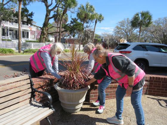 Amanda Wise, Sarah McCullough and Peggy Roselle work in the container gardens in front of the historic courthouse on Wednesday.. Photo by Amy Mulligan/News-Leader