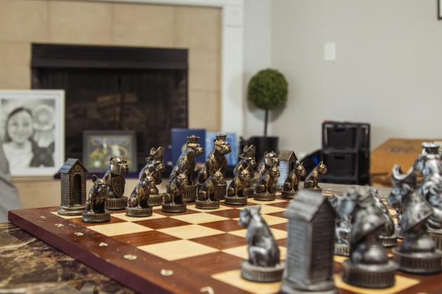 At Christine Roldan's parents house, a custom chess board is displayed prominently on the living room coffee table. The pieces feature different bully breeds. Photo by Ashley Chandler/News-Leader