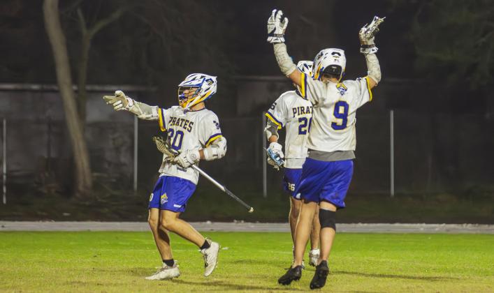 Pirate Senior Ben Adams, left, celebrates one of his six goals on Friday night against Sandalwood. Photo by Ashley Chandler/News-Leader