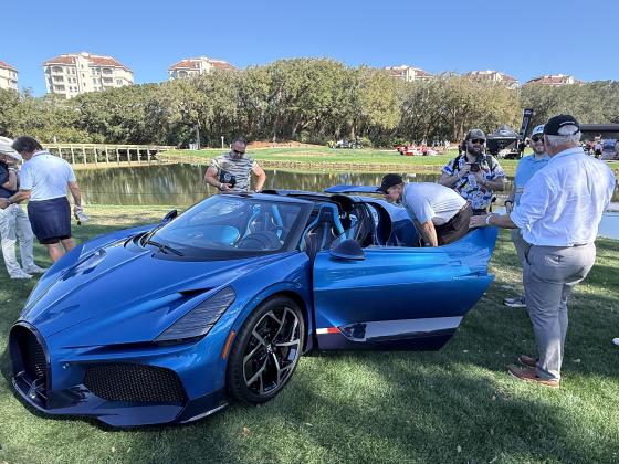 Tom Hill, right, fields questions about a Bugatti Mistral that he’s the caretaker for. He compared driving the car, of which 99 were made, to riding a bull. Nick Blank/News-Leader