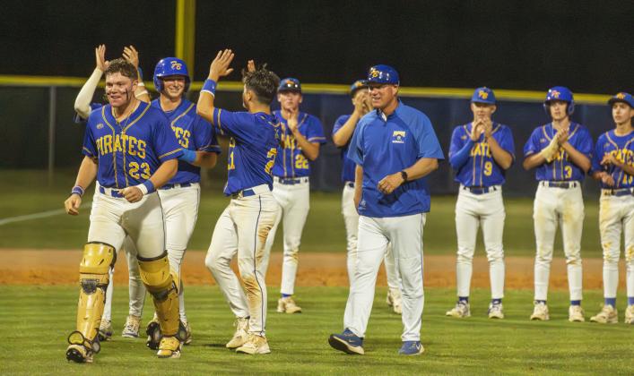 Pirates Lucas Hutchinson, No. 23; Conner Bayless No. 4; John Addington, No. 21; and Landen Holbrook, back left, along with Head Coach Jon Shave, right, receive the 2026 District Champions trophy Thursday from FBHS Athletic Director Mike Woodard. Photo by Ashley Chandler/News-Leader
