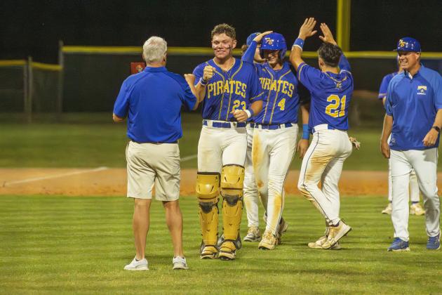 Pirates Lucas Hutchinson, No. 23; Conner Bayless No. 4; John Addington, No. 21; and Landen Holbrook, back left, along with Head Coach Jon Shave, right, receive the 2026 District Champions trophy Thursday from FBHS Athletic Director Mike Woodard. Photo by Ashley Chandler/News-Leader
