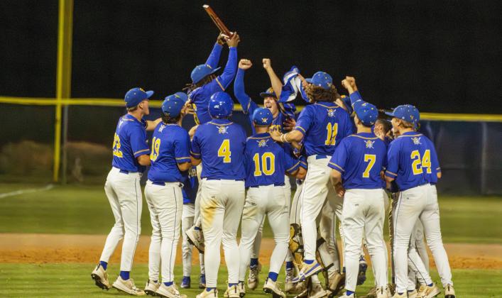 The Pirates celebrate earning the district title last week. Photo by Ashley Chandler/News-Leader