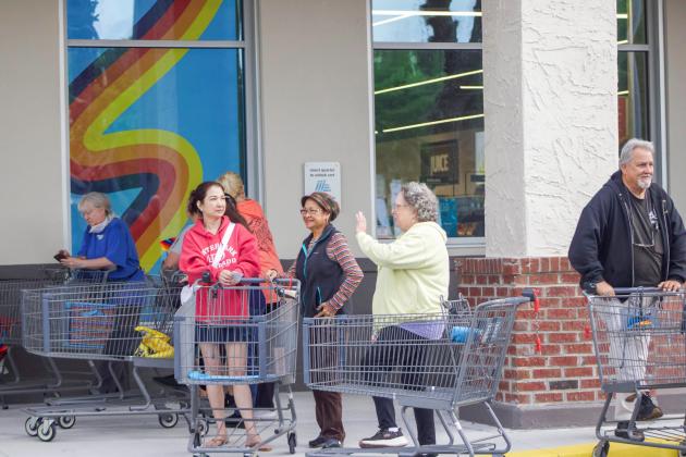 A line of people formed outside ALDI on Thursday for a ribbon cutting event to celebrate the opening of the new ALDI, formerly Winn-Dixie. Photo by Marisa DeMar/News-Leader