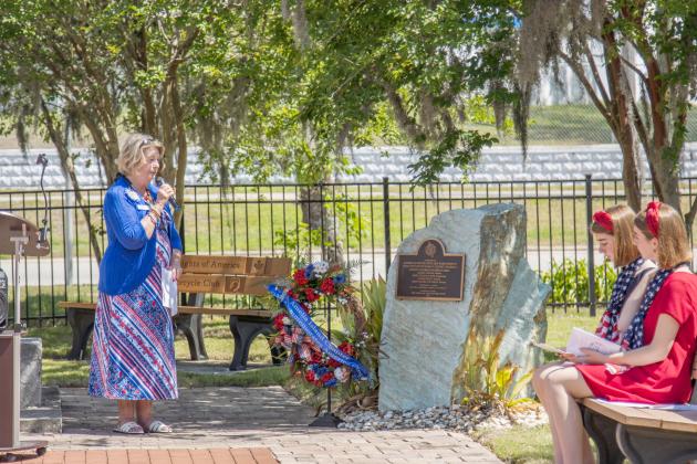 Diane Hishta, left, regent for the Amelia Island Chapter of the National Society Daughters of American Revolution, leads the wreath-laying ceremony Saturday at the Veterans Memorial at Central Park in Fernandina Beach. Photo by Ashley Chandler/News-Leader