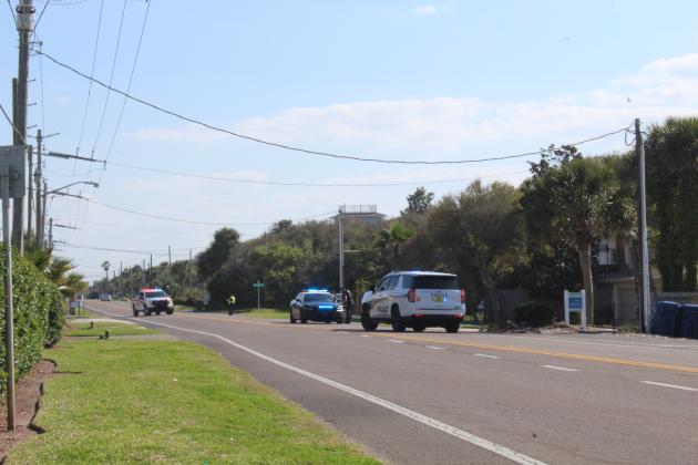 Officers on the scene of an incident invovling an SUV and a bicycle March 27 on South Fletcher Avenue. Amy Mulligan/News-Leader 