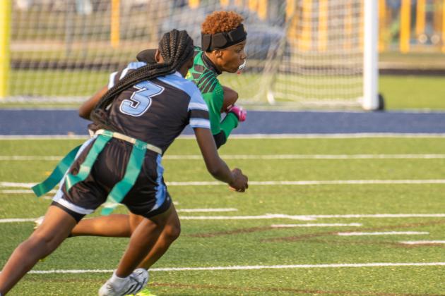 Yulee High School’s Rheyna Hilton carries the ball past a Ribault player in Tuesday’s district matchup. Photo by Nick Blank/News-Leader