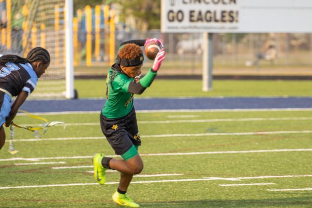 Yulee High School’s Rheyna Hilton carries the ball past a Ribault player in Tuesday’s district matchup. Photo by Nick Blank/News-Leader