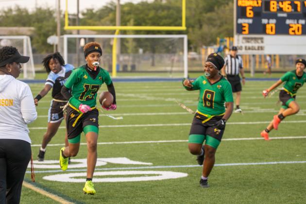 Yulee High School’s Rheyna Hilton carries the ball past a Ribault player in Tuesday’s district matchup. Photo by Nick Blank/News-Leader