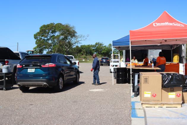 Volunteers and Clean Harbors, the company contracted for both events, help locals to unload items to discard at Saturday’s Household Hazardous Waste Collection in Fernandina Beach. Photo by Ashley Chandler/News-Leader
