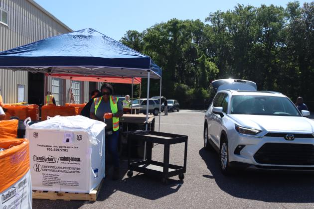 Volunteers and Clean Harbors, the company contracted for both events, help locals to unload items to discard at Saturday’s Household Hazardous Waste Collection in Fernandina Beach. Photo by Ashley Chandler/News-Leader