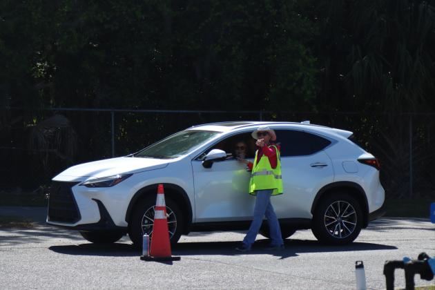 Volunteers and Clean Harbors, the company contracted for both events, help locals to unload items to discard at Saturday’s Household Hazardous Waste Collection in Fernandina Beach. Photo by Ashley Chandler/News-Leader