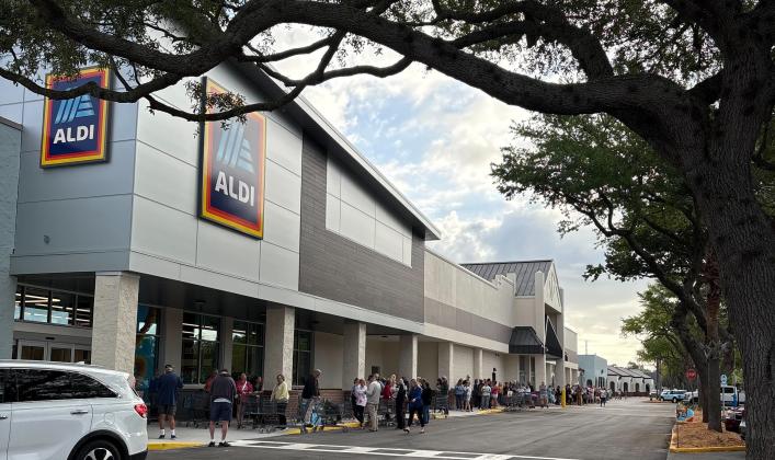 A line of people formed outside ALDI on Thursday for a ribbon cutting event to celebrate the opening of the new ALDI, formerly Winn-Dixie. Photo by Marisa DeMar/News-Leader