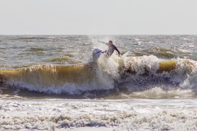 Surfers Aiden Flynn, CJ Rogers and Noah Poteat were out on the water Sunday at Main Beach. Photo by Marisa DeMar/News-Leader