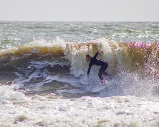 Surfers Aiden Flynn, CJ Rogers and Noah Poteat were out on the water Sunday at Main Beach. Photo by Marisa DeMar/News-Leader