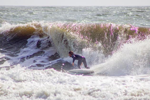 Surfers Aiden Flynn, CJ Rogers and Noah Poteat were out on the water Sunday at Main Beach. Photo by Marisa DeMar/News-Leader