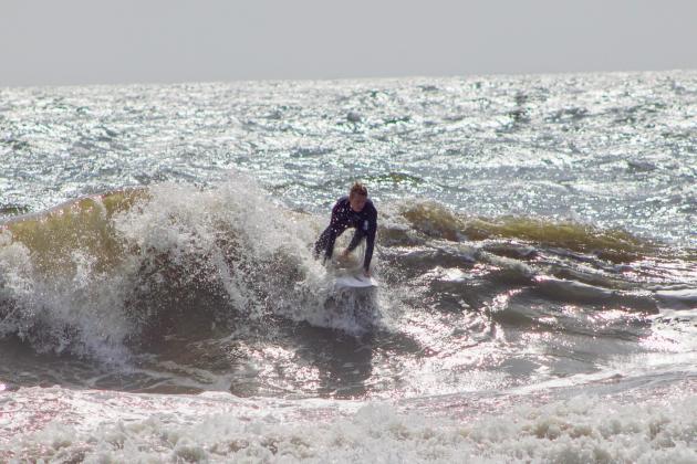 Surfers Aiden Flynn, CJ Rogers and Noah Poteat were out on the water Sunday at Main Beach. Photo by Marisa DeMar/News-Leader