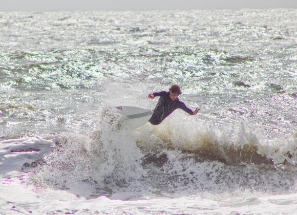 Surfers Aiden Flynn, CJ Rogers and Noah Poteat were out on the water Sunday at Main Beach. Photo by Marisa DeMar/News-Leader