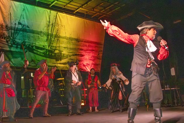 Brian Leary, also known as Swordmaster, right, on stage during the Pirate Invasion on Friday. Leary composed the music for the Pirate Club’s program. Photo by Ashley Chandler/News-Leader