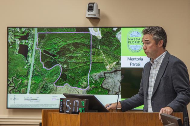 Taylor Clem discusses potential future uses for the 223 acres the county purchased at the April 27 Board of County Commissioners meeting. Staff says the property will be used mostly for conservation purposes. Photo by Ashley Chandler/News-Leader