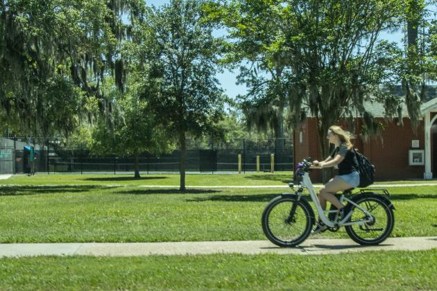 A woman rides an e-bike May 20 down Atlantic Avenue. Photo Ashley Chandler/News-Leader