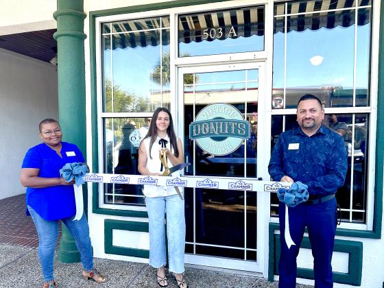 Charity Stiers holds a ribbon cutting ceremony with the Nassau County Chamber of Commerce staff to celebrate her new ownership on Monday. Submitted photo