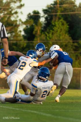 Fernandina Beach High School’s Tanner Duffy, and CJ Crosby make a tackle in Wednesday’s spring football game. No. 2 Aydin Poe watches. PHOTOS COURTESY OF MEGAN LOUISE PHOTOS