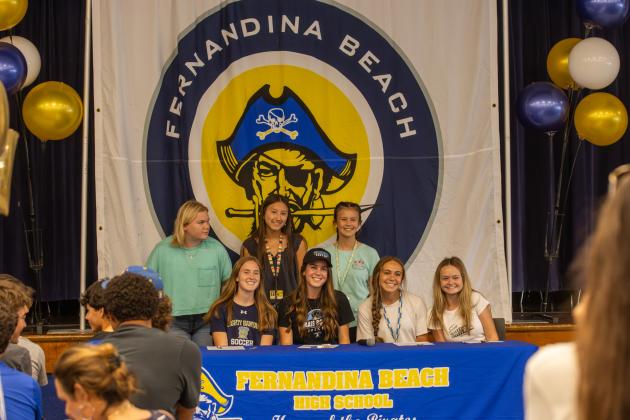 Charleston Knight poses with her FBHS soccer teammates at her signing ceremony to celebrate her committing to play soccer at the University of Massachusetts Boston.  Photo by Ashley Chandler/News-Leader