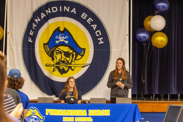 Amy Strozinsky, FBHS girls soccer head coach (right), speaks about Sarah Benjamin’s accolades Wednesday at FBHS during her signing cereomy to play at New College of Florida. Photo by Ashley Chandler/News-Leader