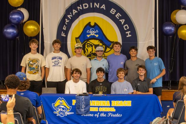 Brady Steffen with FBHS golfers during his signing ceremony Wednesday at Fernandina Beach High School. Steffen signed to play golf for New College of Florida. Photo by Ashley Chandler/News-Leader