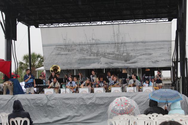 The Fernandina Beach High School Jazz Ensemble performed in the rain Saturday morning at the 61st annual Eight Flags Shrimp Festival. Photo by Amy Mulligan/News-Leader