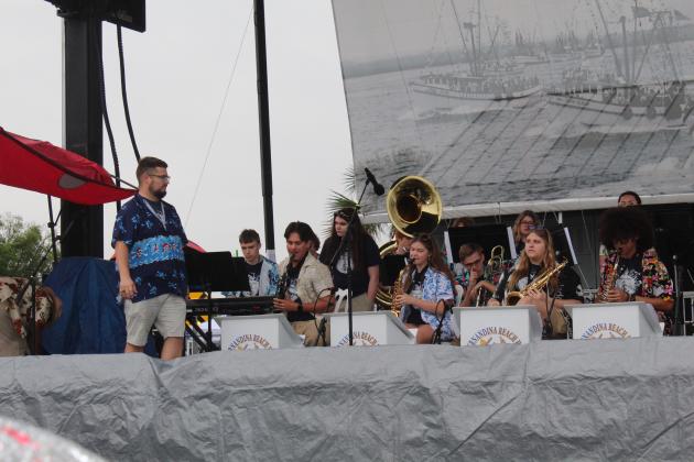 The Fernandina Beach High School Jazz Ensemble performed in the rain Saturday morning at the 61st annual Eight Flags Shrimp Festival. Photo by Amy Mulligan/News-Leader