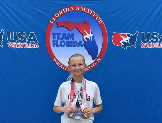 Journey Flannery shows off her hardware after winning two of her three divisions at at the Father Devine National Team Qualifier &amp; Championship and making Team Florida. Submitted photo