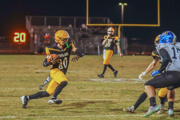 Peter Kuhlman carries the ball for Yulee High School in a 2025 game. Photo by Ashley Chandler/News-Leader